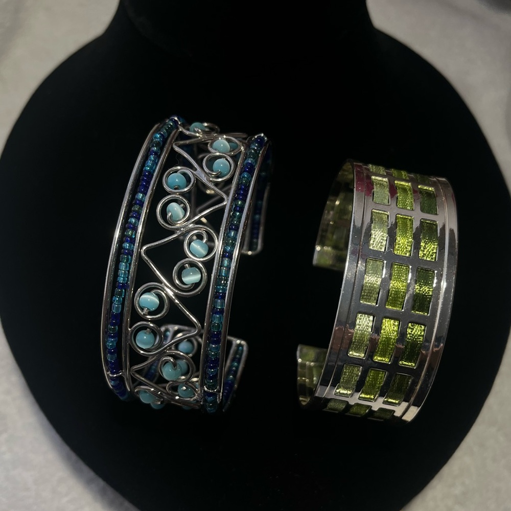 Set of 2 silver tone cuff bracelets.